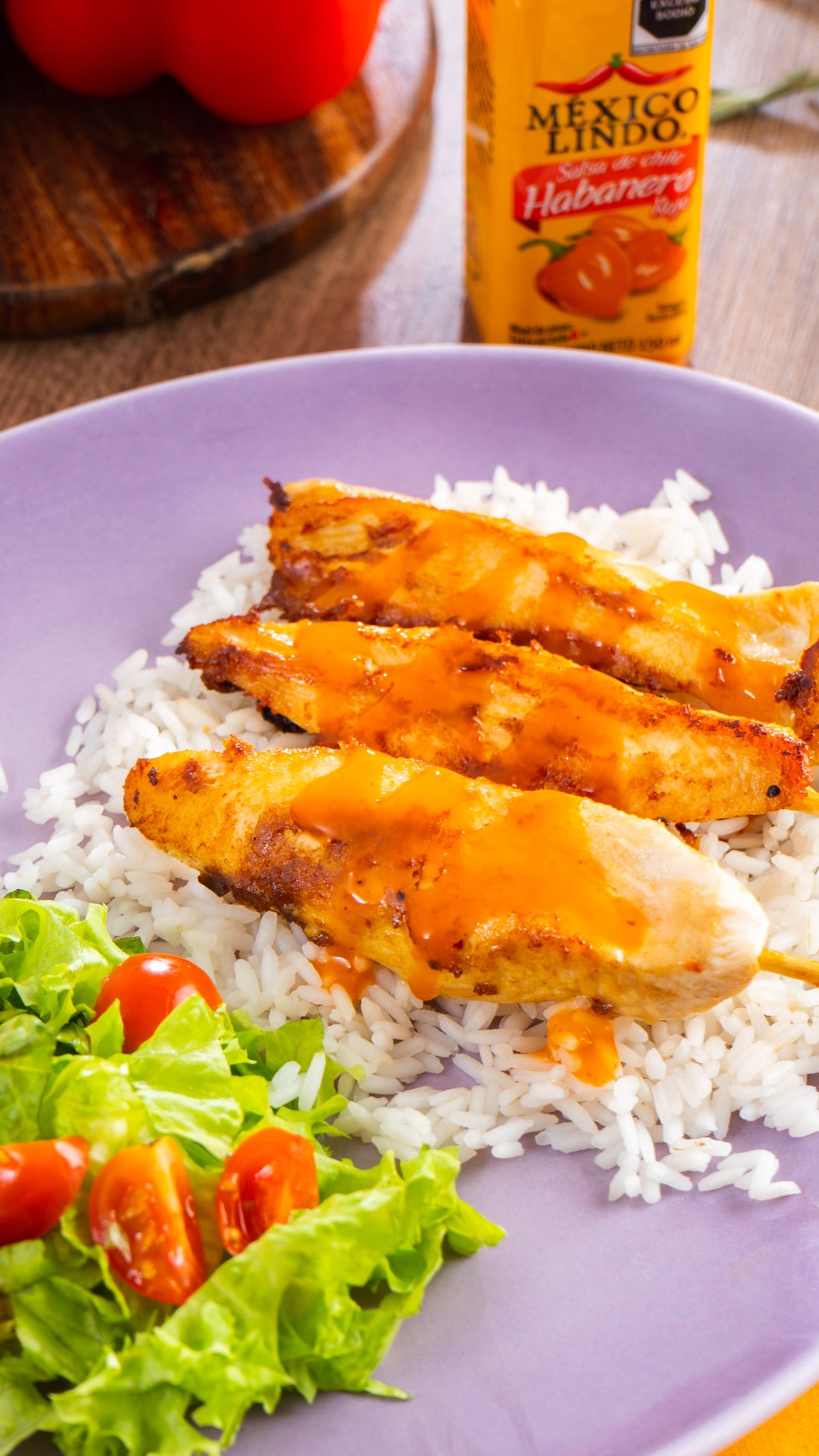 Deliciosas Bochetas de Pollo Satay en una cama de arroz blanco con una deliciosa ensalada fresca y salseado con Salsas México Lindo Habanero Rojo.